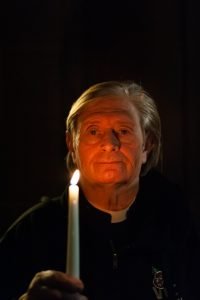 Vicar holds lit candle in memory of son